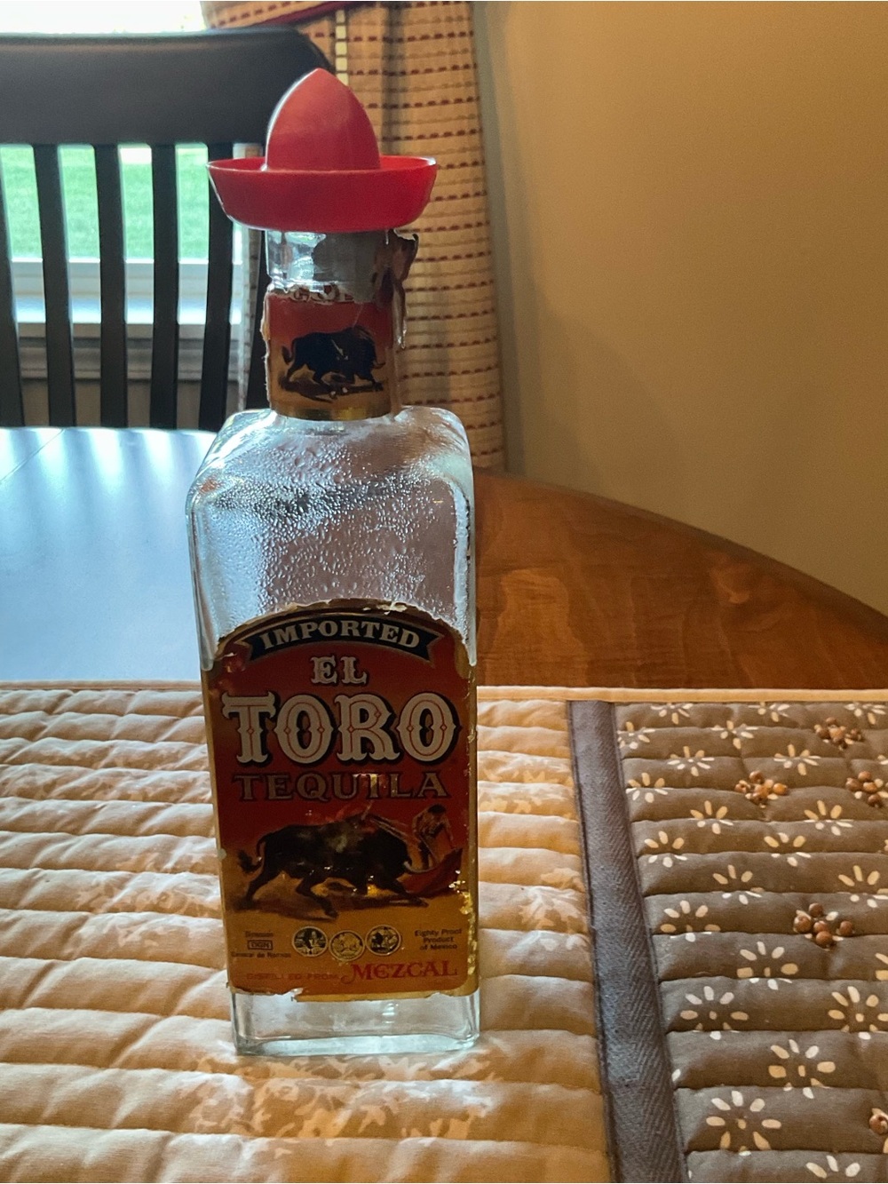 El Toro Tequila Bottle with Red sombrero Accents